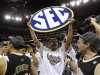 **ADDS NAME OF PLAYER WITH SIGN** Vanderbilt forward Jeffery Taylor, leading scorer, holds up an SEC sign after Vanderbilt won the  2012 Southeastern Conference tournament at the New Orleans Arena in New Orleans, Sunday, March 11, 2012. Vanderbilt beat Kentucky 71-64. (AP Photo/Gerald Herbert)
