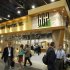 Attendees pass by the General Growth Properties booth during the International Council of Shopping Centers convention in Las Vegas