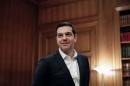 Greek PM Tsipras waits for United Nations High Commissioner for Refugees Grandi for a meeting at his office at the Maximos Mansion in Athens