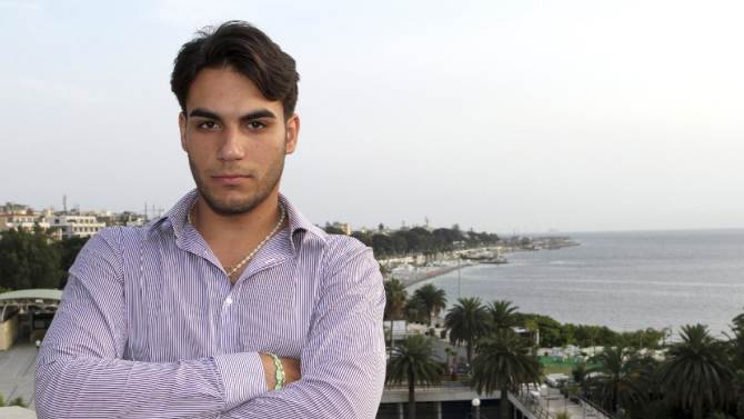 In this June 26, 2014 photo, Riccardo Cordi&#39; stands on a terrace in Reggio Calabria, Sicily, Italy with the Strait of Messina in the background. Cordi&#39; was exiled to Messina during a pioneering anti-mafia program for juveniles, a kind of rehab away from the mob. (AP Photo/Adriana Sapone)