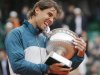 Nadal of Spain bites the trophy after defeating compatriot Ferrer in their men's singles final match to win the French Open tennis tournament in Paris