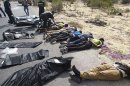 In this image obtained from an Egyptian emergency service worker which has been authenticated based on its contents and other AP reporting, bodies of off-duty policemen who were killed near the border town of Rafah, North Sinai, Egypt, lie on the ground Monday, Aug. 19, 2013. Islamic militants on Monday ambushed two mini-buses carrying off-duty policemen in the northern region of Egypt's Sinai Peninsula, killing more than two dozen of them execution-style in a brazen daylight attack that deepens the turmoil roiling the country and underscores the volatility of the strategic region. (AP Photo)