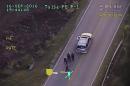 In this image made from a Friday, Sept. 16, 2016 police video, Terence Crutcher, top, is pursued by police officers as he walk to an SUV in Tulsa, Okla. Crutcher was taken to the hospital where he was pronounced dead after he was shot by the officer around 8 p.m., Friday, police said. Crutcher had no weapon on him or in his SUV, Tulsa Police Chief Chuck Jordan said Monday, Sept. 19, 2016. (Tulsa Police Department via AP)