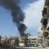 Smoke rises after shelling in Al-khalidiya neighbourhood in Homs