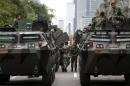 Military armoured personnel carriers are seen near the site of an attack in central Jakarta