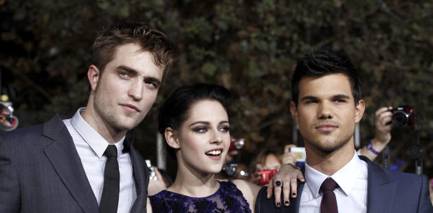 Robert Pattinson, left, Kristen Stewart, center, and Taylor Lautner arrive at the world premiere of "The Twilight Saga: Breaking Dawn - Part 1" on Monday, Nov. 14, 2011, in Los Angeles. (AP Photo/Matt Sayles)