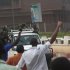 Civilians cheer as mutinous soldiers drive past in Bamako, Mali Wednesday March 21, 2012. Gunshots could still be heard in the Malian capital late Wednesday, hours after angry troops started a mutiny at a military base near the presidential palace. Soldiers stormed the offices of the state broadcaster, yanking both TV and radio off the air.(AP Photo/Harouna Traore)