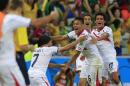 Costa Rica's Oscar Duarte, center, celebrates after scoring his side's second goal during the group D World Cup soccer match between Uruguay and Costa Rica at the Arena Castelao in Fortaleza, Brazil, Saturday, June 14, 2014. (AP Photo/Bernat Armangue)