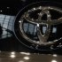A visitor is reflected on a Toyota car at the company's showroom in Tokyo