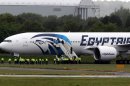 Passengers leave the Egyptair aircraft at Prestwick Airport, Scotland, after it was diverted while en route from Cairo to New York, Saturday June 15, 2013. It is reported that BBC employee Nada Tafik, who was on board the plane, said she found a note in a toilet apparently threatening to start a fire. The plane was escorted to Prestwick by Typhoon fighters from RAF Leuchars, near St. Andrews on the east coast of Scotland. (AP Photo/ Andrew Milligan /PA) UNITED KINGDOM OUT