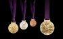 A handout image obtained from the London 2012 organising committee (LOCOG) on July 27, 2011 shows the London 2012 Olympic medals designed by British artist David Watkins. The Olympic medals’ circular form is a metaphor for the world. The front of the medal always depicts the same imagery at the summer Games, the Greek Goddess of Victory, Nike, stepping out of the depiction of the Parthenon to arrive in the host city. The design for the reverse of the London 2012 Olympic medals contains five main symbolic elements: the dished background suggests a bowl similar to the design of an amphitheatre, the core emblem is an architectural expression, a metaphor for the modern City, the grid brings both a pulling together and sense of outreach on the design - an image of radiating energy that represents the athletes’ achievements and effort, the River Thames is a symbol for London and the square is the final balancing motif of the design, opposing the overall circularity of the design and emphasising its focus on the centre and reinforcing the sense of ‘place’ as in a map inset. AFP PHOTO / LOCOG/ HO

ATTENTION - EMBARGO, RELEASABLE Wednesday July 27, 2011 at 1830 GMT - THIS RESTRICTION APPLIES TO ALL MEDIA INCLUDING WEBSITES 
 ---- EDITORS NOTE ---- RESTRICTED TO EDITORIAL USE - MANDATORY CREDIT *AFP PHOTO / LOCOG/ HO* - NO MARKETING NO ADVERTISING CAMPAIGNS - DISTRIBUTED AS A SERVICE TO CLIENTS (Photo credit should read HO/AFP/Getty Images)