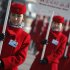 Hostesses holds hotel signboards to guide delegates after the closing ceremony of the Chinese People's Political Consultative Conference outside Beijing's Great Hall of the People in China, Tuesday, March 13, 2012. (AP Photo/ Vincent Thian)