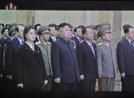 Kim Jong-Un (C) and his wife Ri Sol-Ju can be seen in this screen grab taken from North Korean TV on December 17, 2012 attending a ceremony marking the first anniversary of his father Kim Jong-Il's death. The late ruler died of a heart attack on December 17, 2011
