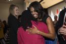 First lady Michelle Obama greets people after speaking at the Women Veterans Career Development Forum at the Women in Military Service for America Memorial (WIMSA) at Arlington National Cemetery in Arlington, Va., Monday, Nov. 10, 2014. (AP Photo/Susan Walsh)