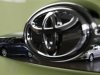 Toyota's Corolla Fielder and Corolla Axio are reflected in a Toyota Forte's logo in Tokyo