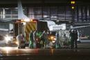 An Ebola patient is put on a Hercules transport plane at Glasgow Airport