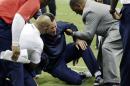 Houston Texans head coach Gary Kubiak, center, his helped after he collapsed on the field during the second quarter of an NFL football game against the Indianapolis Colts, Sunday, Nov. 3, 2013, in Houston. (AP Photo/David J. Phillip)
