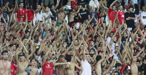 Fans of Etoile Sportive du Sahel cheer before their team's African Champions League soccer match against Esperance Sportive de Tunis at the Sousse olympic stadium