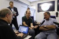 U.S. Secretary of Defense Leon Panetta (R) speaks to the press aboard his aircraft on his way to an official visit to Japan, China and New Zealand, September 15, 2012. REUTERS/Larry Downing