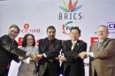 (From L - R) Brazilian TM Pimentel, Russia's EDM Nabiullina, India's TM Sharma, China's Minister of Commerce Deming and South African Minister of Trade and Industry Davies shake hands during a group photograph at the BRICS Summit Forum in New Delhi