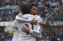 Real Madrid's Gareth Bale, left, celebrates his goal with Real Madrid's Cristiano Ronaldo during a Spanish La Liga soccer match between Getafe and Real Madrid at the Coliseum Alfonso Perez stadium in Madrid, Spain, Sunday, Jan. 18, 2015. (AP Photo/Andres Kudacki)