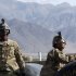 U.S. Army soldiers of PRT Laghman, 1st Battalion, 143 Airborne Infantry wait for the helicopter transporting supplies and fuel to different U.S. military bases to hoist its rope at Forward Operating Base Methar Lam in Laghman province
