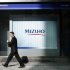A man walks past a branch of Mizuho bank belonging to Mizuho Financial Group in Tokyo