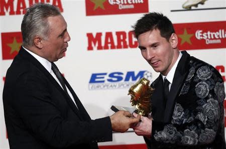 Barcelona's soccer player Messi receives the Golden Boot trophy from former player Stoichkov during an award ceremony in Barcelona