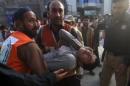 Rescue workers carry a man, who was injured during an earthquake, at the Lady Reading hospital, Peshawar