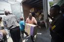 A worker deliver boxes of gloves to the General Hospital in Port-au-Prince, Haiti, Thursday, May 12, 2016. Doctors have refused to take new patients since late March, saying the government isn't providing supplies or compensating them fairly. A truckload of basic medical supplies has been delivered but resident doctors say it's not nearly enough to end their weeks-old strike. (AP Photo/Dieu Nalio Chery)