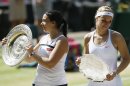 Marion Bartoli of France, left, and Sabine Lisicki of Germany pose during the trophy ceremony after Bartoli won the Women's singles final match against at the All England Lawn Tennis Championships in Wimbledon, London, Saturday, July 6, 2013. (AP Photo/Kirsty Wigglesworth)