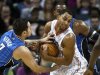Bobcats guard Henderson fights for control of the ball against Magic shooting guard Redick in their NBA game in Charlotte