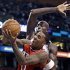 Atlanta Hawks guard Jeff Teague, front, gets past Boston Celtics forward Kevin Garnett, who starts to swipe his arm on a block, during the second half of Game 3 of an NBA first-round playoff basketball series, Friday, May 4, 2012, in Boston. (AP Photo/Charles Krupa)