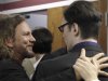 Eddie Vedder of the rock band Pearl Jam, left, embraces Damien Echols, one of three men released Friday, Aug. 19, 2011, at the Craighead County Court House in Jonesboro, Ark., after pleading guilty to crimes they say they did not commit. The three men, convicted of killing three 8-year-old Cub Scouts and dumping their bodies in an Arkansas ditch in 1993, were freed from nearly two decades in prison Friday, after they agreed to plead guilty to secure the release Echols from death row. Vedder became a key supporter of the men after watching a pair of documentaries about the case. (AP Photo/Danny Johnston)
