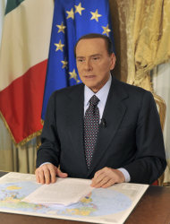 In this photo released by the Berlusconi press office
   Thursday,
 Oct. 25, 2012, former Italian premier Silvio Berlusconi tapes a video message where he
 announces he will not run for a fourth term as premier in spring elections. Berlusconi has until now been coy about his intentions. But the three-time former premier posted a statement on his movement's website yesterday, under the headline: "I won't run for premier.", following today with a video where he confirms his intentions. (AP Photo/Livio Anticoli, Berlusconi press office)