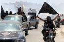 Fighters from Al-Qaeda's Syrian affiliate Al-Nusra Front drive in Aleppo flying Islamist flags, May 26, 2015