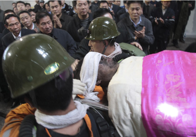 Rescuers move an injured miner at the Qianqiu Coal Mine in Yima city in central China's Henan province Friday, Nov. 4, 2011. Rescuers pulled seven injured miners to the surface Friday and were trying 