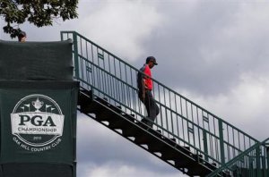Woods walks to the first tee during the final round of the 2013 PGA Championship golf tournament at Oak Hill Country Club in Rochester