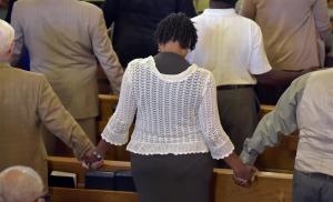 People attend a prayer service to mourn the lives lost&nbsp;&hellip;