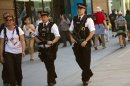 Police officers patrol near the Olympic Park in London, Monday, July 23, 2012. Opening ceremonies for the 2012 London Olympics are scheduled for Friday, July 27. (AP Photo/Emilio Morenatti)