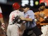 Philadelphia Phillies' Shane Victorino, left, is restrained by home plate umpire Mike Muchlinski, after Victorino was hit by a pitch thrown by San Francisco Giants' Ramon Ramirez, right, during the inning of a baseball game Friday, Aug. 5, 2011, in San Francisco. The altercation caused a benches clearing brawl. (AP Photo/Ben Margot)