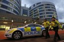 Police officers patrol outside the emergency entrance of the Queen Elizabeth Hospital where injured Pakistani teenager Malala Yousufzai arrived for treatment in Birmingham, central England