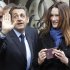 French President and UMP candidate Nicolas Sarkozy and his wife Carla Bruni-Sarkozy leave after casting their votes in the first round of French presidential elections in Paris, France, Sunday, April 22, 2012.  (AP Photo/Michel Euler)