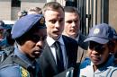 South African Paralympic athlete Oscar Pistorius arrives at the High Court in Pretoria on October 13, 2014