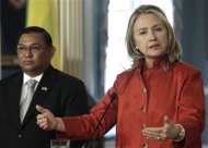 U.S. Secretary of State Hillary Clinton (R) speaks to reporters next to Burma's Foreign Minister Wunna Maung Lwin after their meeting at the State Department in Washington May 17, 2012. REUTERS/Yuri Gripas