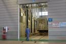 A CRRC worker walks past an unfinished metro train car in the company's Kunming factory