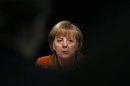 German Chancellor Angela Merkel answers questions from reporters after a meeting in Munich