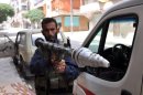 A Syrian rebel holds a rocket propelled grenade during clashes with pro-regime forces in Aleppo