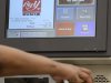 In this Sept. 23, 2011 photo, a customer uses a self-serve checkout station at a Big Y supermarket in Manchester, Conn. A growing number of supermarket chains are bagging their self-serve checkout lanes, saying they can offer better customer service when clerks help shoppers directly. Big Y Foods, which has more than 60 southern New England locations, recently became the latest to announce it's phasing them out. (AP Photo/Jessica Hill)