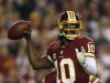 Redskins quarterback Griffin III throws against the Giants defense during their NFL football game in Landover